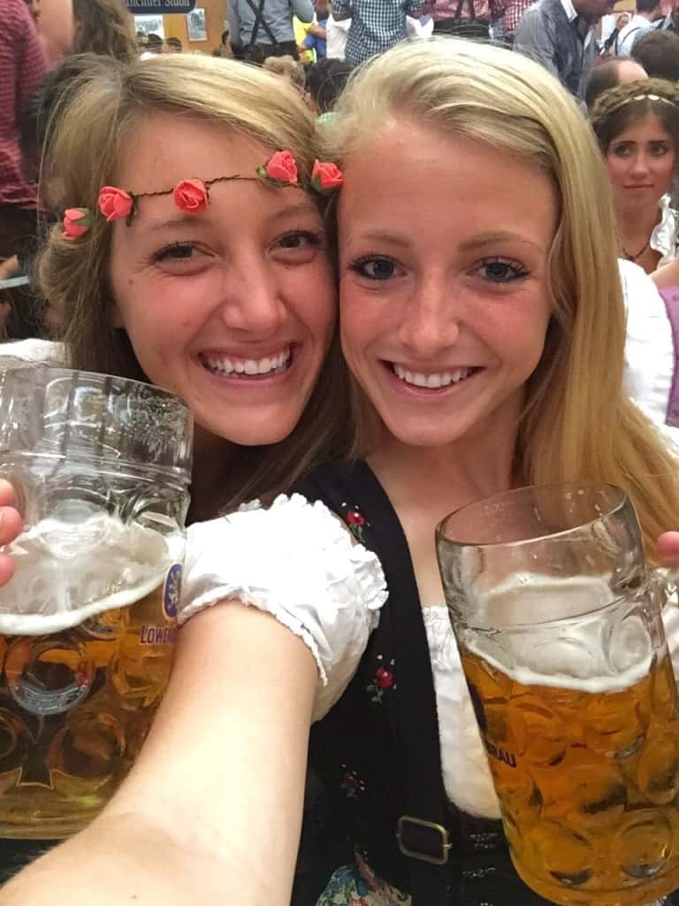 Two girls (one is me) smiling for a picture with beers in their hands.