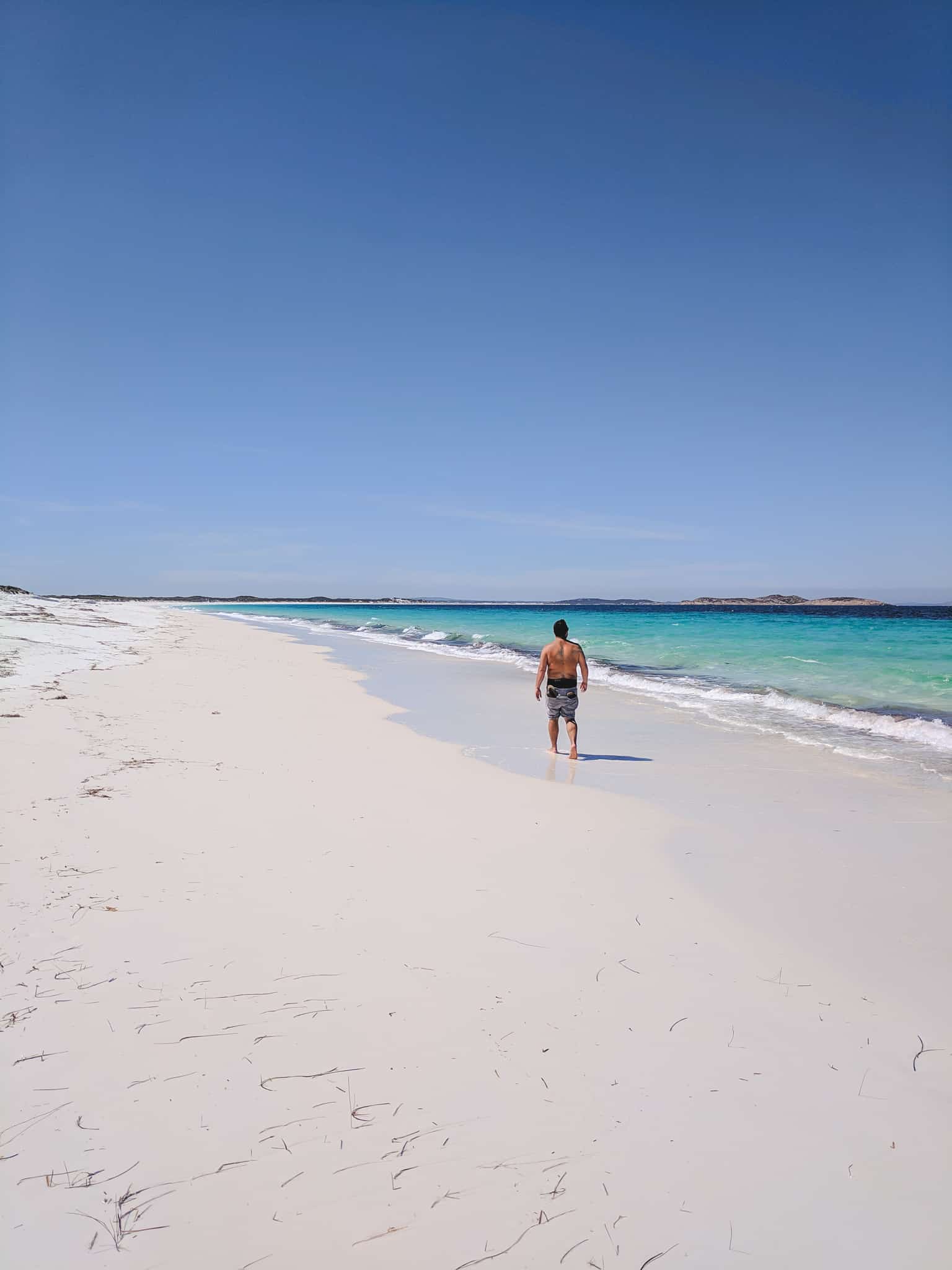 Mike walking down the coastline of Rossiter Bay in Cape Le Grand National Park
