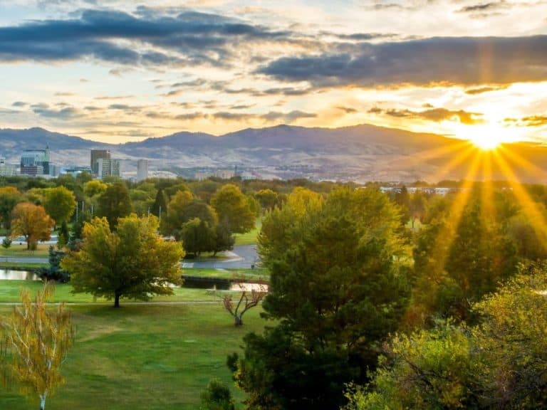 Sunrise on downtown Boise, Idaho during the summer. The mountains in the background in a slight fog.
