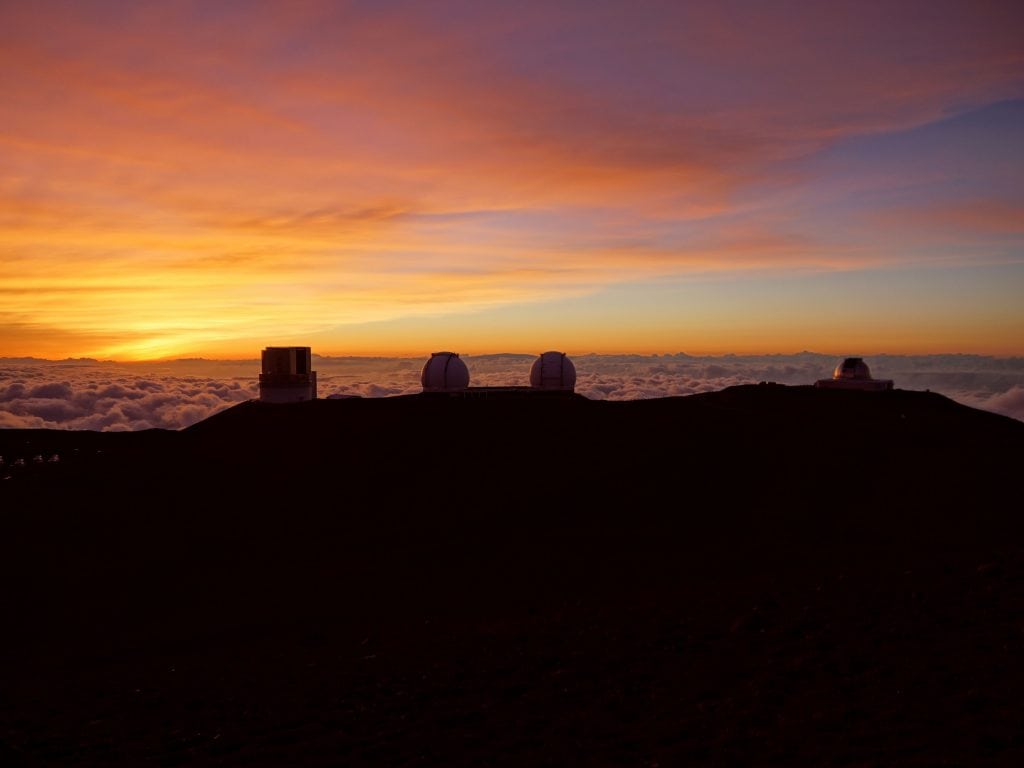 Sunrise Over The Big Island With The Telescopes Visable.