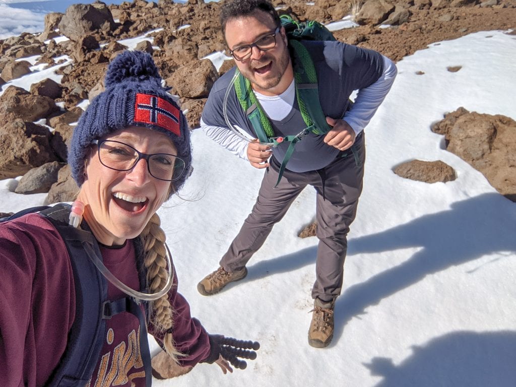 Mike & Laura Standing On Snow With Excitement on the Way To The Top of Mauna Kea.