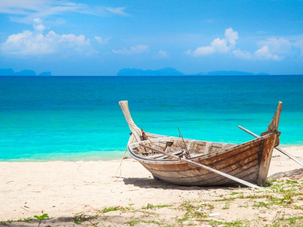 Wooden Boat on the Beach in Koh Lanta, Thailand, A Great Destination For Island Hopping.