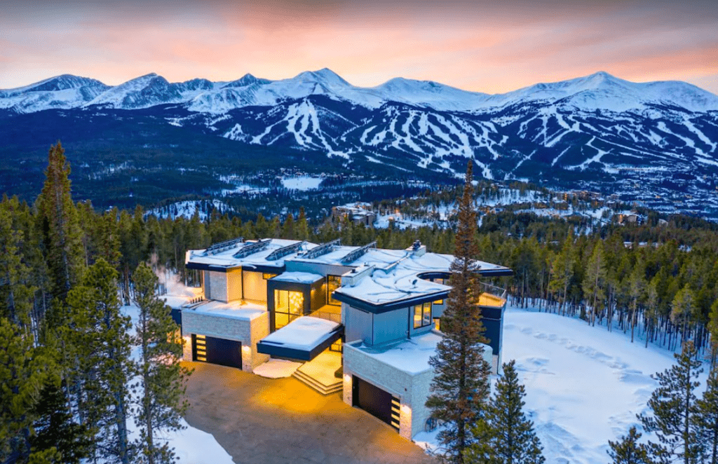 An Upscale Home With The Rocky Mountains In The Background.