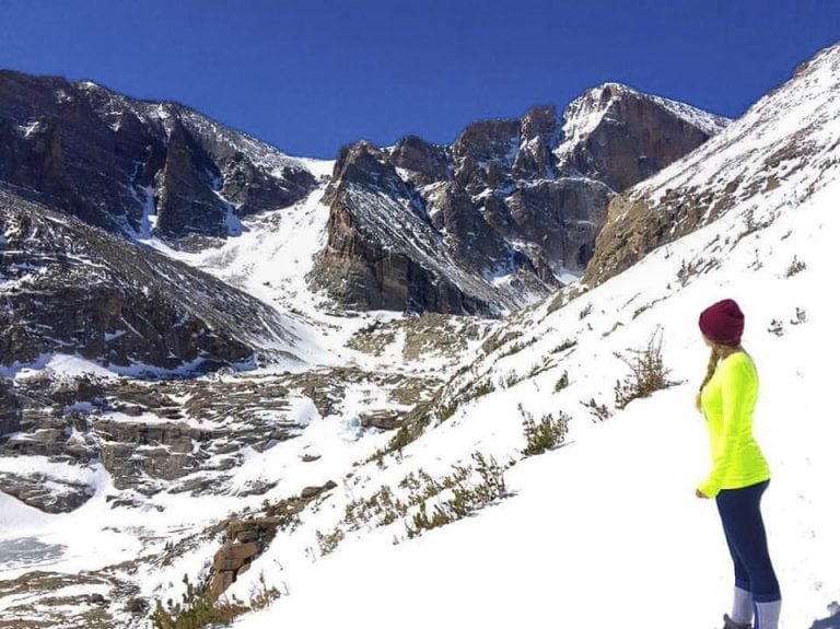 Laura Standing Near Longs Peak During Winter, One of the Best Day Trips From Denver.