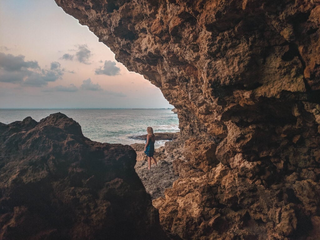 Standing on rock next to the ocean in Bali.