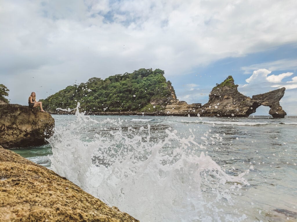Laura sitting on a rock on Nusa Penida Island.