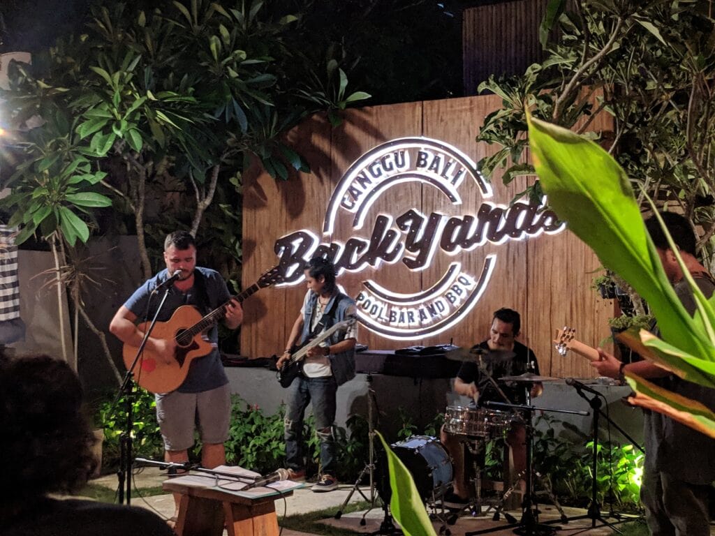 Reduce cost of living by finding a job in Bali - Mike playing music in Canggu.