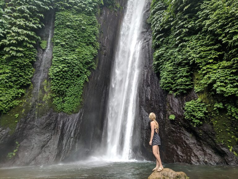 Laura standing under waterfall.