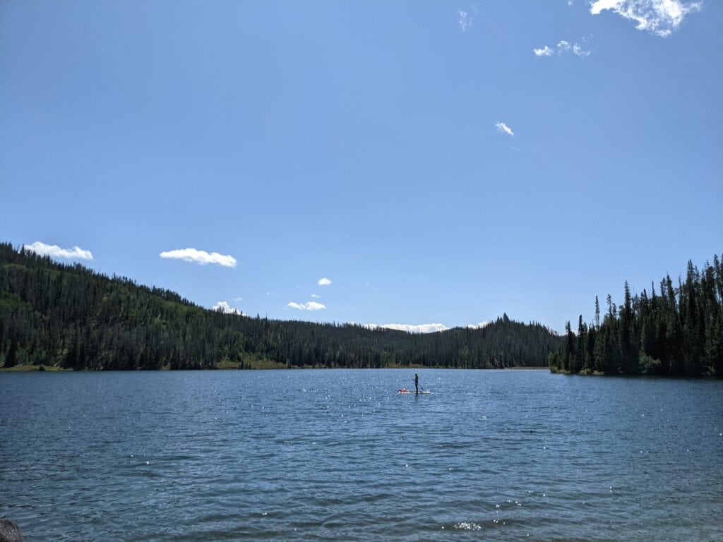 Pearl Lake with a paddleboarder - a great place to camp near Steamboat Springs.