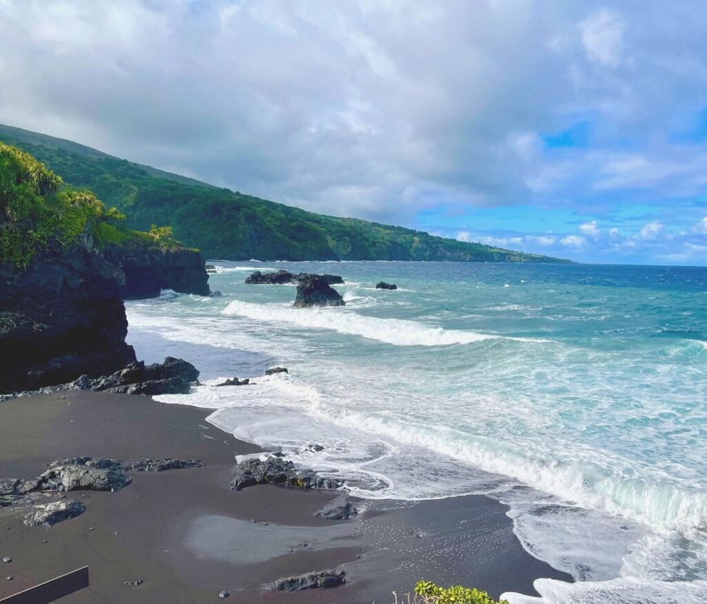 Black sand beach in Maui, seen when driving around the island of Maui