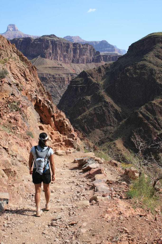 Woman hiking the Bright Angel Trail, one of the best activities to do during a day trip to Grand Canyon National Park.