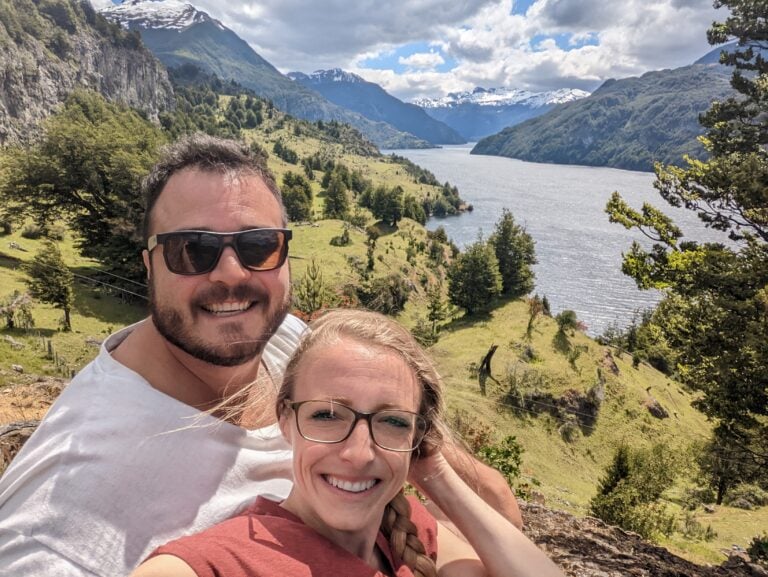 Laura & Mike in Chile amongst trees, a lake, mountains, and more nature.