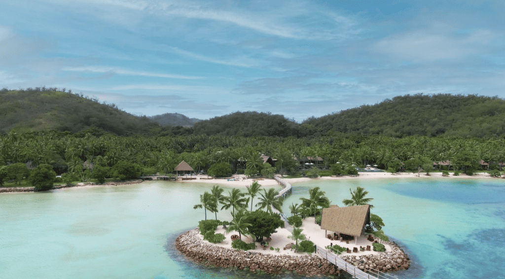 A birds eye view of a tropical island in Fiji with an all inclusive resort.