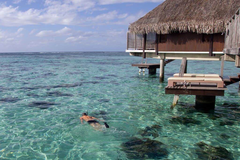 snorkeling in moorea near overwater bungalow