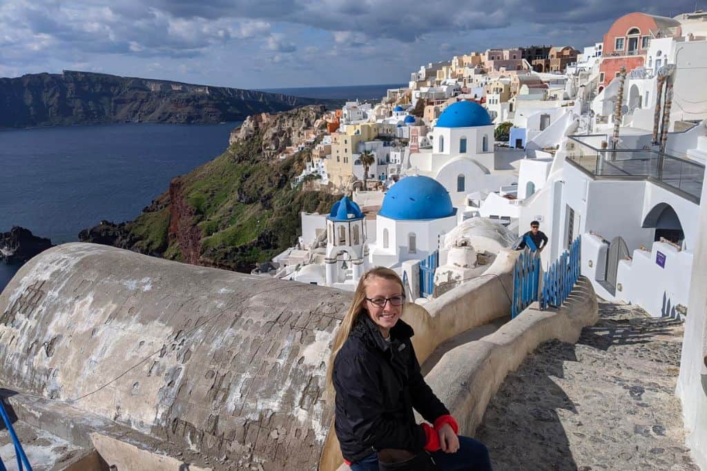 Laura sitting on ledge Cyclades, Greece