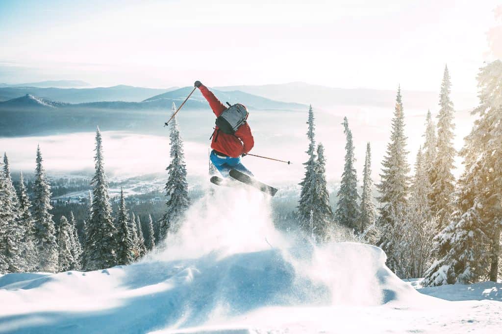 skier mid air going down a slope