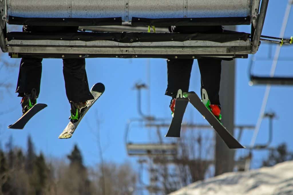 View from under a chair lift with peoples skis