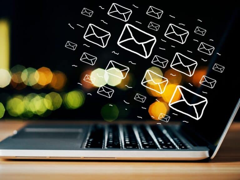 A picture of emails virtually floating above a laptop