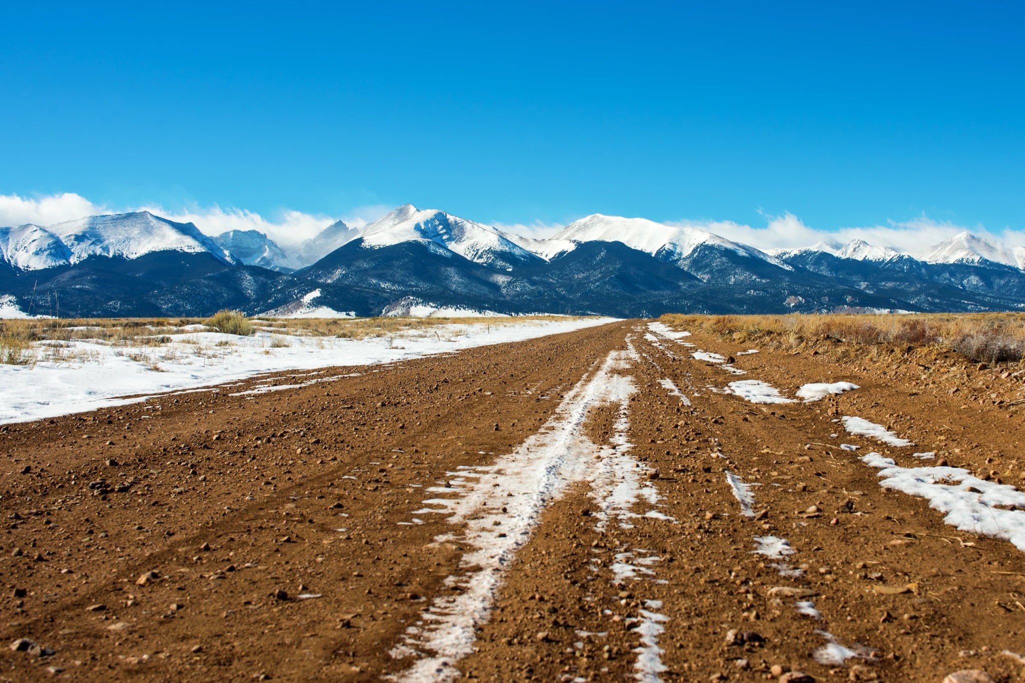 Country road leading to the snowy Sangre de Cristo Mountains in the Wet Mountain Valley